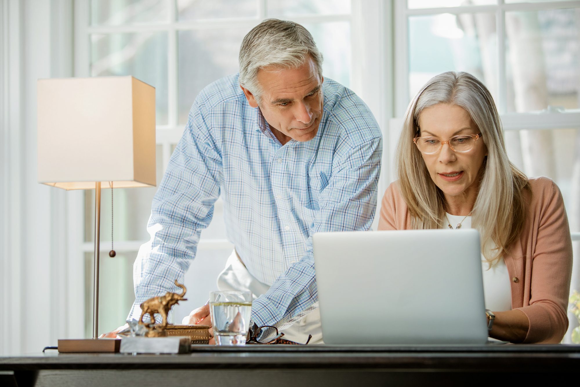 senior couple looking at laptop